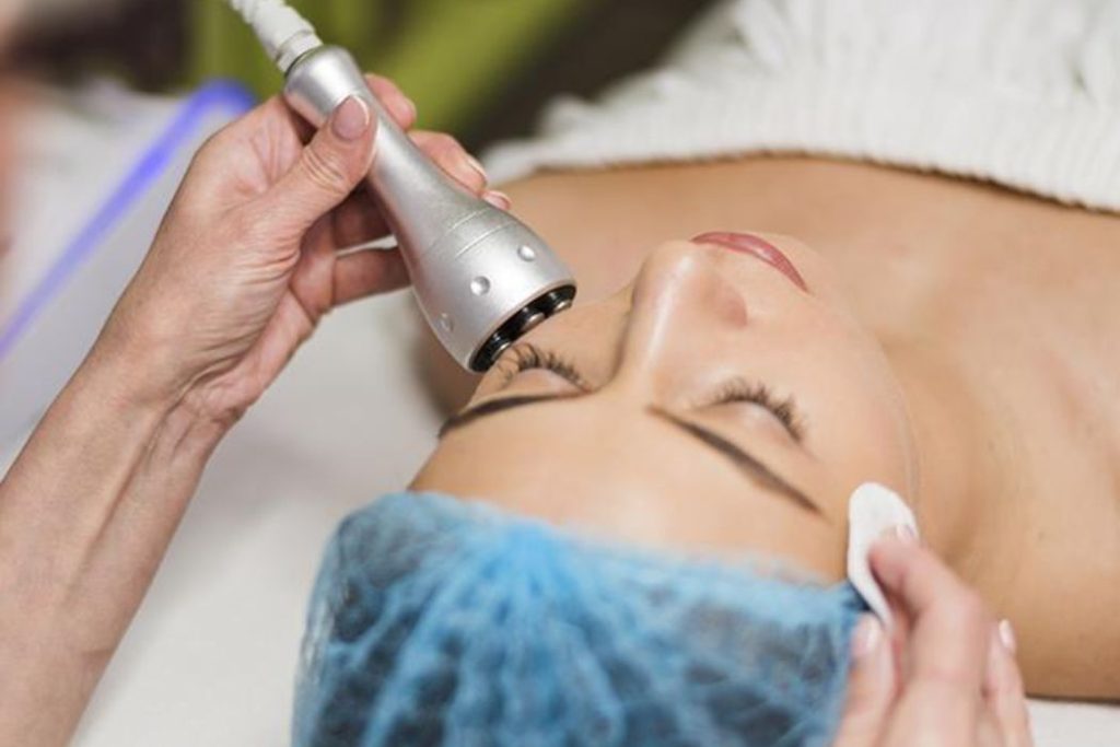 Skincare professional performing a corrective facial treatment to improve skin texture at Namaste Skincare & Wellness in Las Vegas.