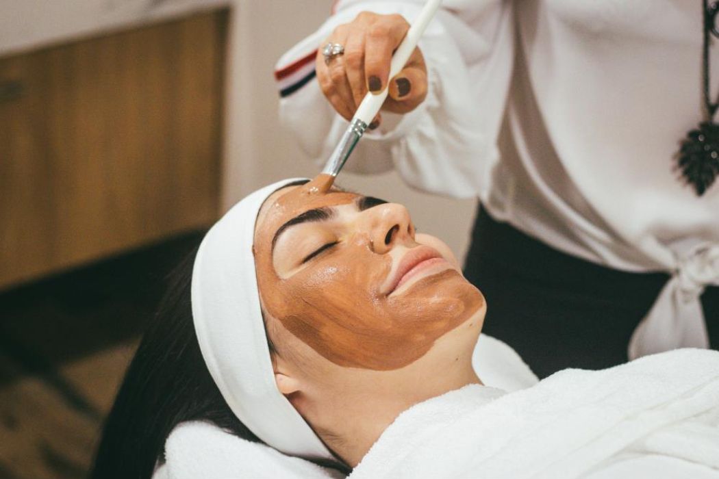 Esthetician applying a facial treatment enhancement to a client’s skin, one of Namaste’s luxury service add-ons for radiant results in Las Vegas.