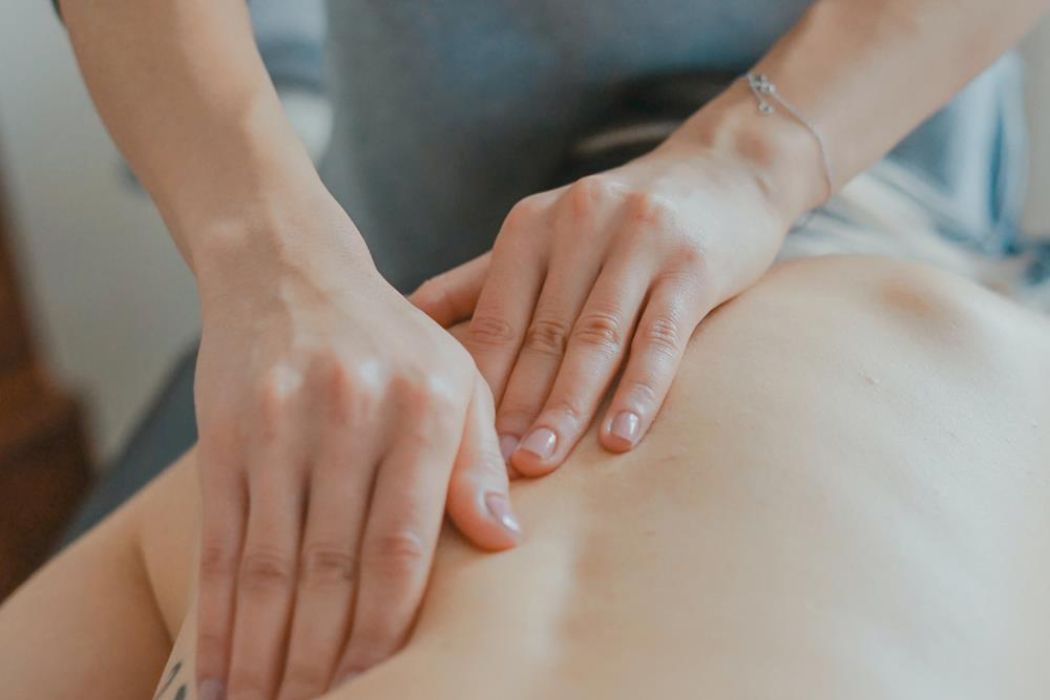 Massage therapist working on a client’s back during a personalized bodywork session, part of Namaste’s mobile massage services in Las Vegas.