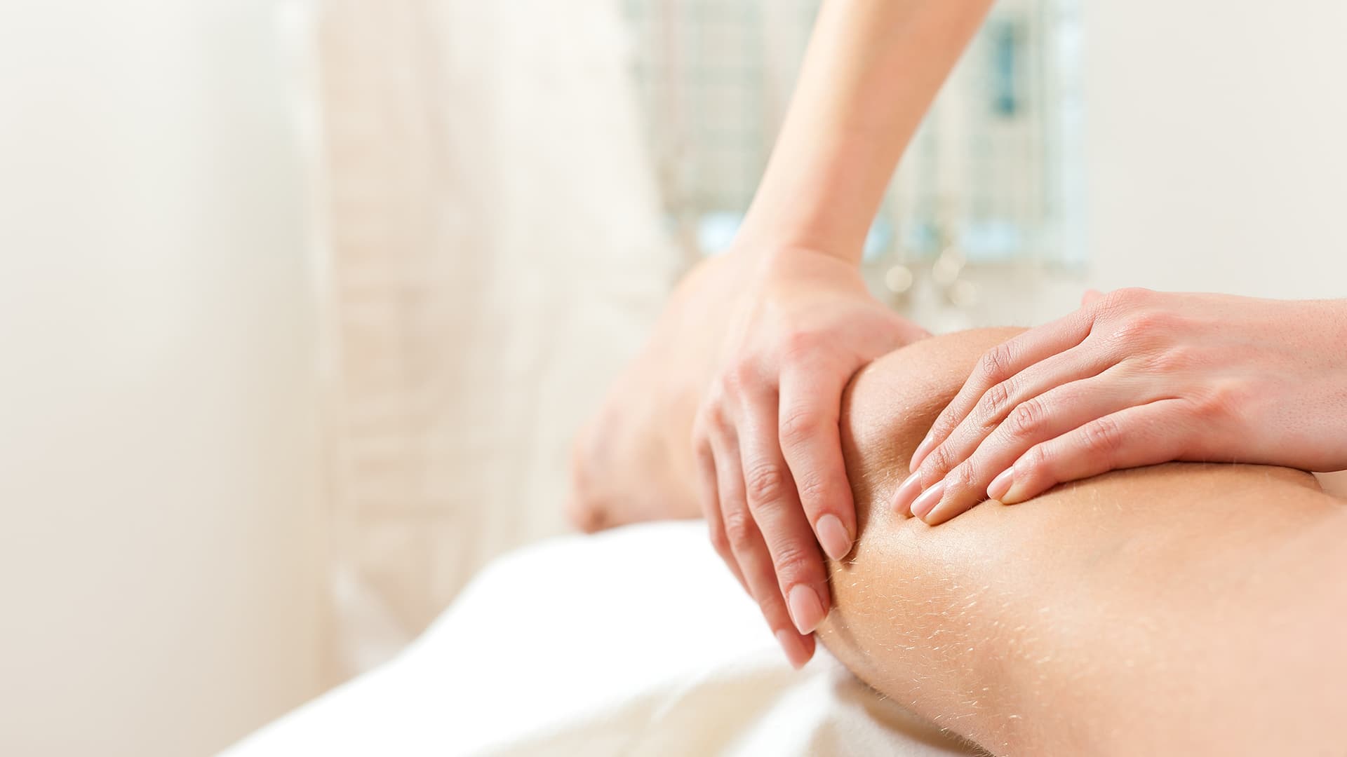 Therapist performing a gentle lymphatic drainage massage on a client at Namaste Skincare & Wellness in Las Vegas, part of post-op recovery care.