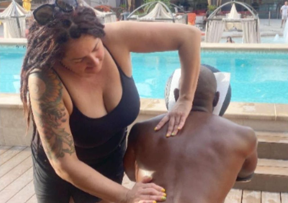 Massage therapist providing a relaxing chair massage to a guest at a Las Vegas casino event, part of Namaste’s on-site wellness services.
